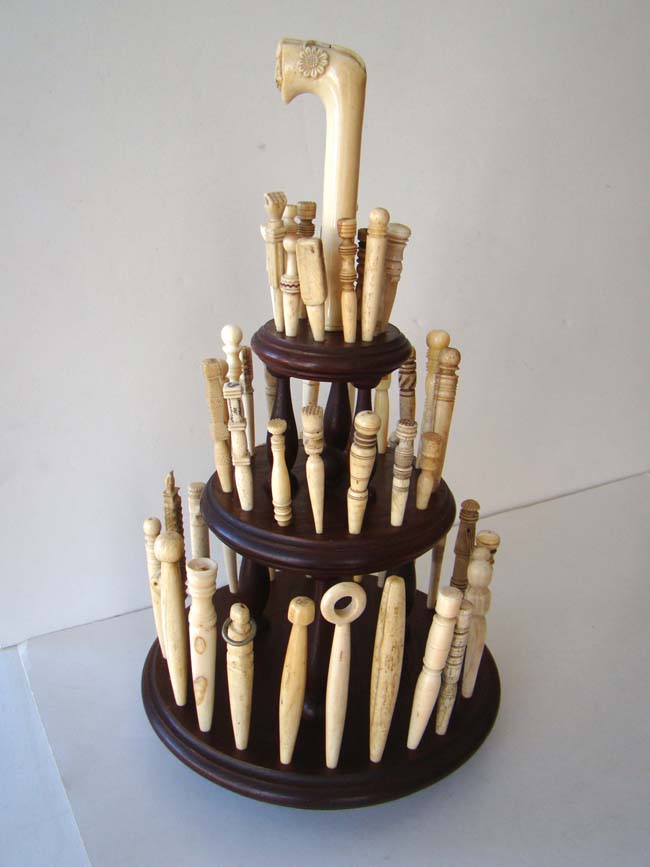 A collection of 46 antique carved whalebone and whale ivory bodkins on a custom made display stand with parasol handle circa 1830-1870.